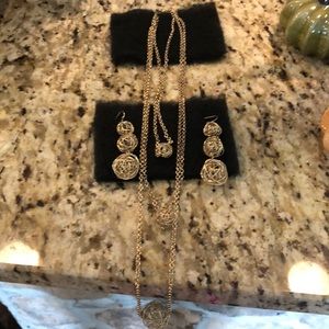 Gold tone necklace and matching earrings.